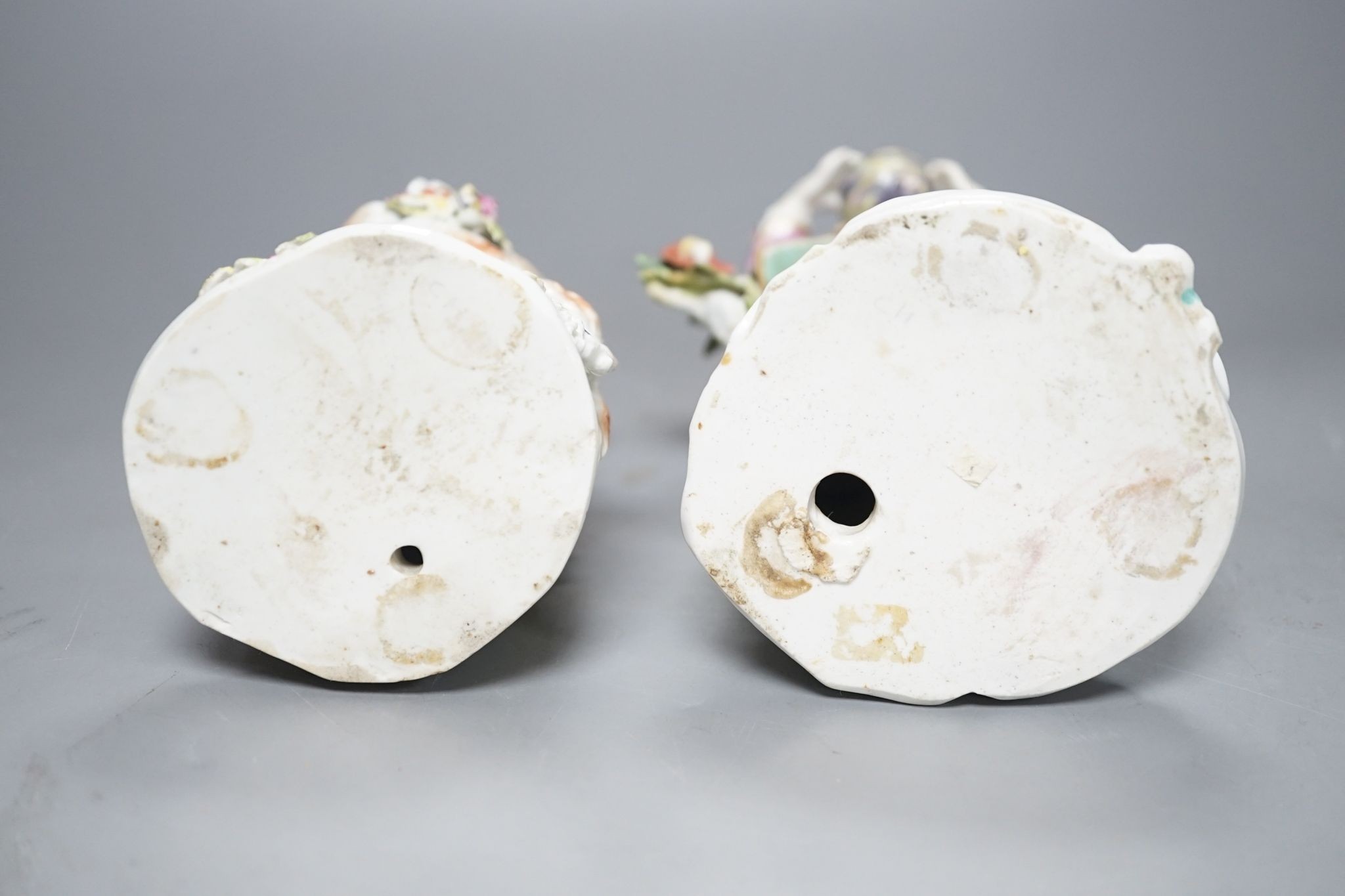 Two Derby porcelain figures of a gentleman holding a bird’s nest and a lady with a sheep, c.1760, 21.5 cms high.